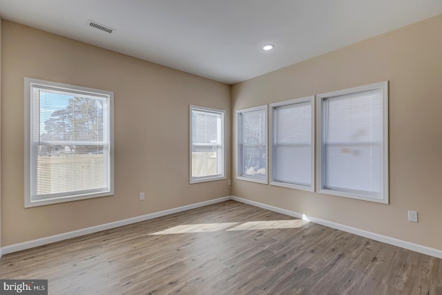 empty room with light hardwood / wood-style flooring