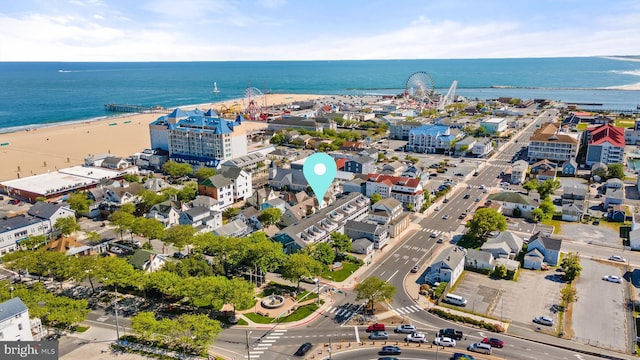 drone / aerial view with a beach view and a water view