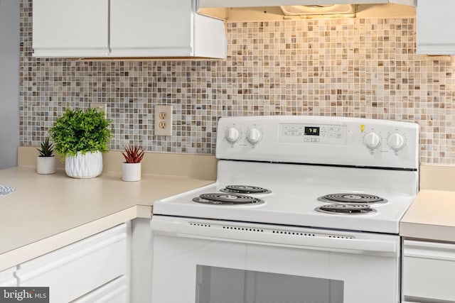 kitchen with electric stove, extractor fan, backsplash, and white cabinets