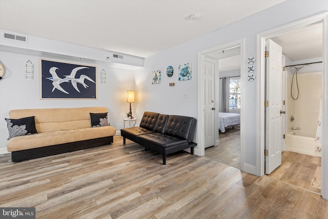 living room with hardwood / wood-style floors and a textured ceiling