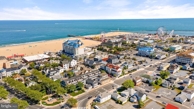 bird's eye view with a water view and a beach view