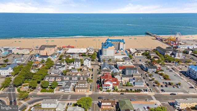 drone / aerial view featuring a water view and a beach view