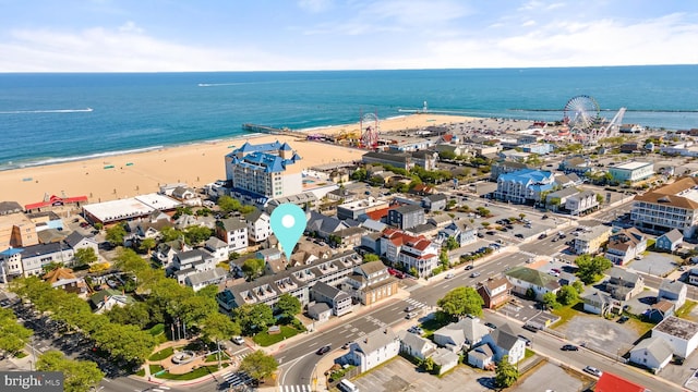 bird's eye view featuring a water view and a beach view