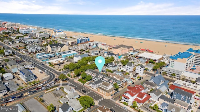 drone / aerial view featuring a beach view and a water view