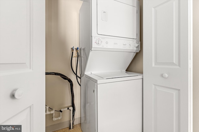 laundry room featuring stacked washer and clothes dryer