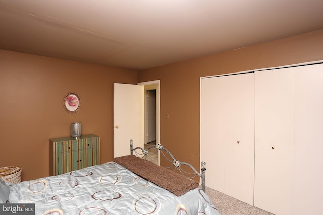 bedroom with light carpet and a closet