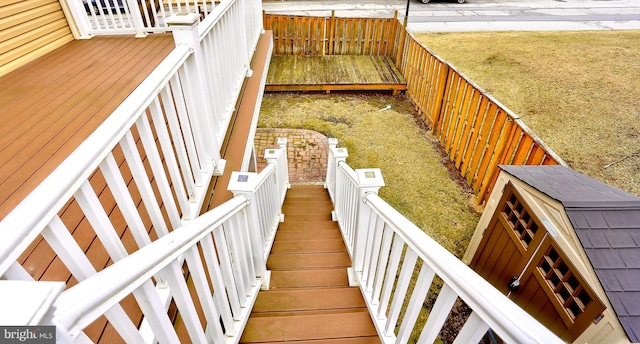 wooden terrace featuring a yard