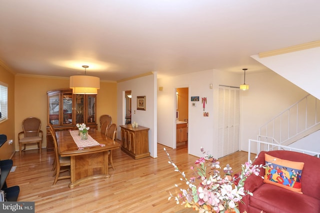 dining room featuring ornamental molding and light hardwood / wood-style floors