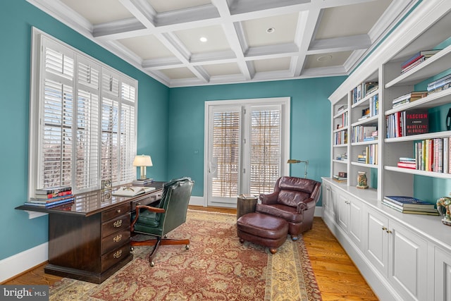 office space featuring ornamental molding, coffered ceiling, beam ceiling, and light hardwood / wood-style flooring