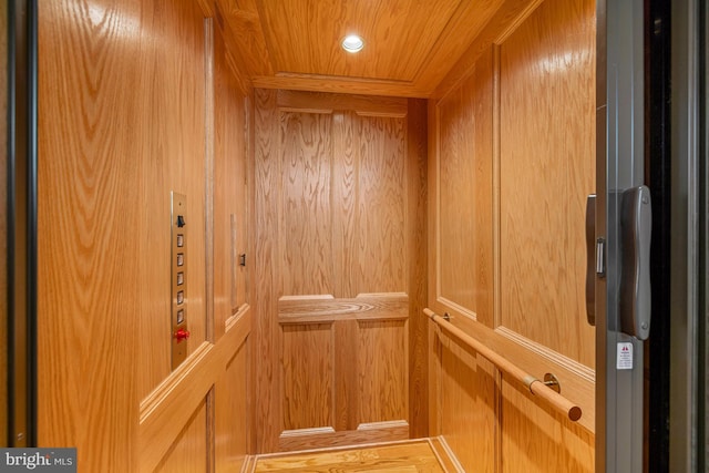 details featuring elevator and wooden ceiling