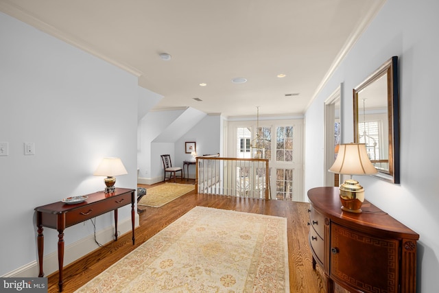 interior space featuring ornamental molding and hardwood / wood-style floors