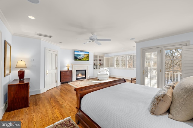 bedroom with access to exterior, crown molding, light hardwood / wood-style flooring, and ceiling fan