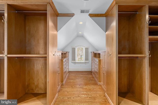 walk in closet featuring lofted ceiling and light wood-type flooring