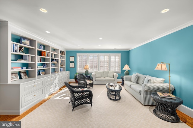 living room with ornamental molding and light hardwood / wood-style floors