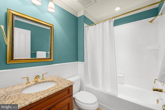 full bathroom featuring shower / bath combo, tile walls, vanity, ornamental molding, and toilet