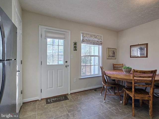 dining space with a textured ceiling