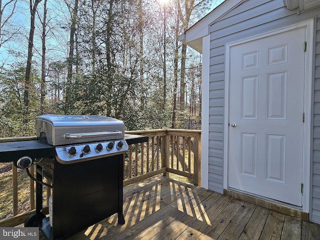 wooden deck featuring a grill