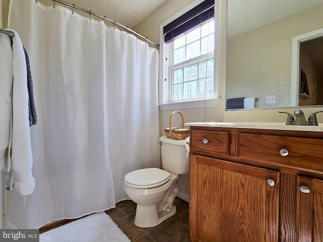 bathroom featuring vanity, tile patterned floors, and toilet