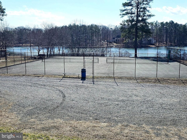 view of sport court with a water view