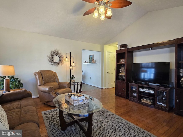 living room featuring lofted ceiling, a textured ceiling, dark hardwood / wood-style floors, and ceiling fan