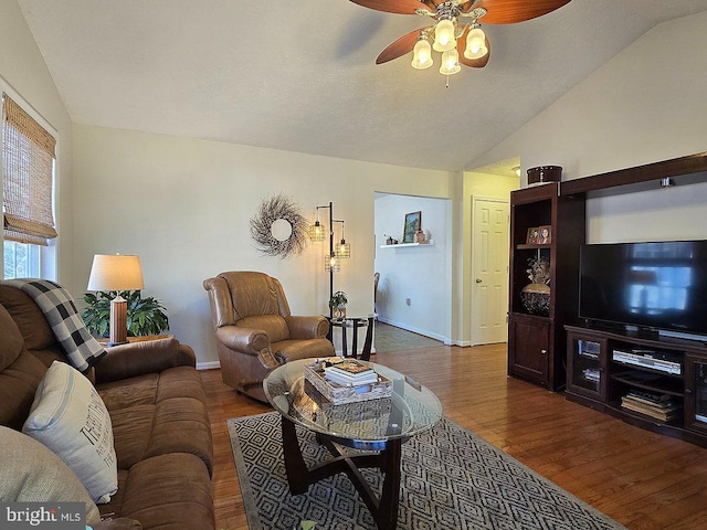 living room with vaulted ceiling, dark hardwood / wood-style floors, and ceiling fan