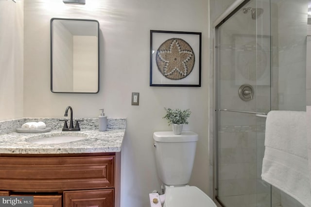 bathroom featuring vanity, toilet, and walk in shower