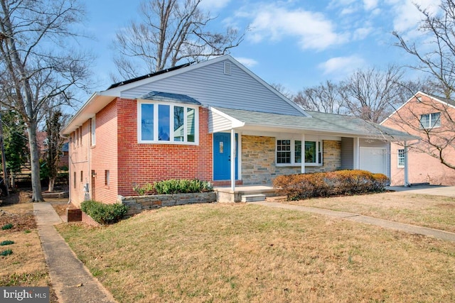 view of front of property with a garage, stone siding, brick siding, and a front lawn