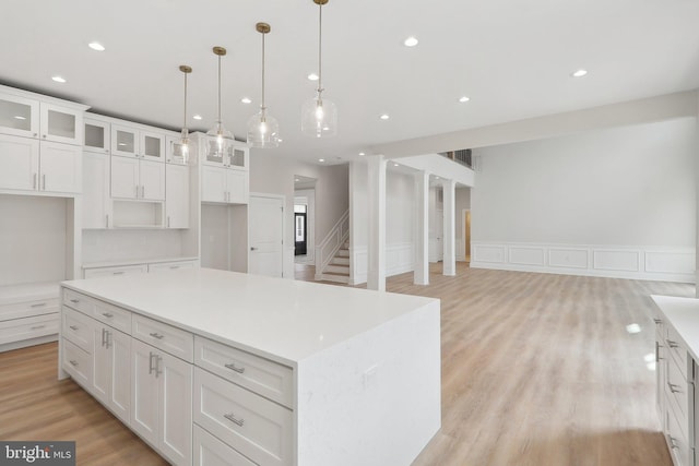 kitchen featuring glass insert cabinets, recessed lighting, light wood-style flooring, and white cabinets