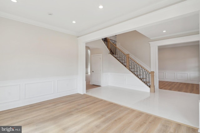 empty room with stairs, wood finished floors, and recessed lighting