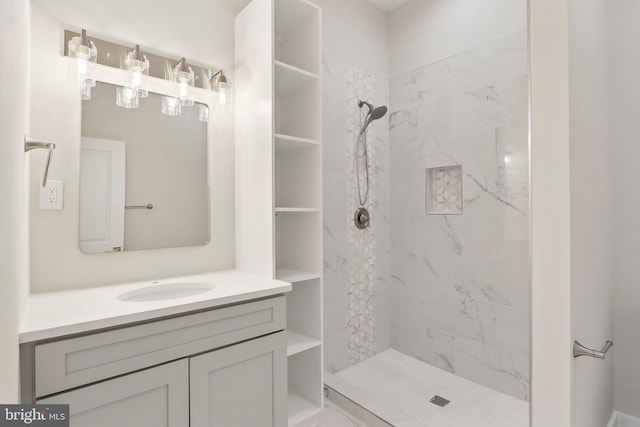 full bathroom with tiled shower and vanity