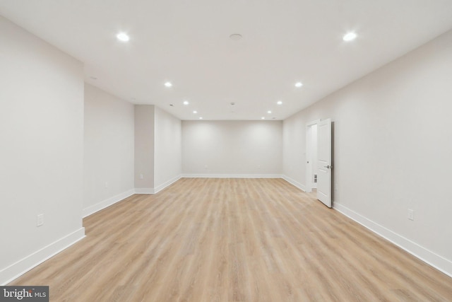 interior space featuring baseboards, light wood-type flooring, and recessed lighting