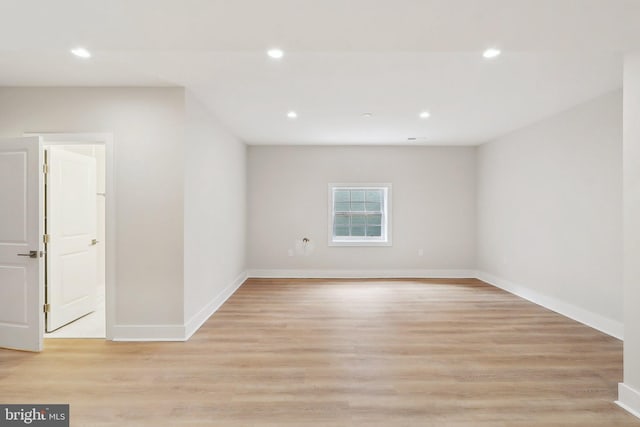 spare room featuring baseboards, light wood finished floors, and recessed lighting