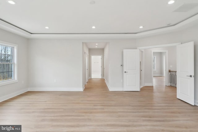 spare room featuring light wood finished floors, baseboards, and recessed lighting