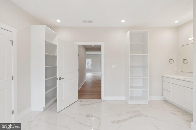 bathroom featuring recessed lighting, marble finish floor, and baseboards