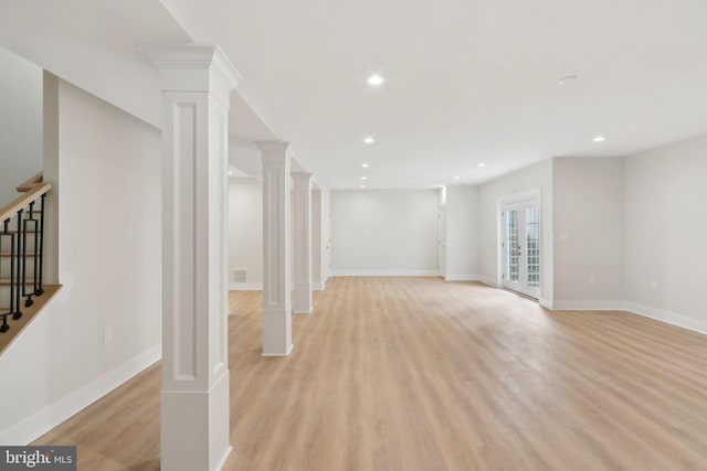 below grade area with light wood finished floors, stairs, baseboards, and recessed lighting