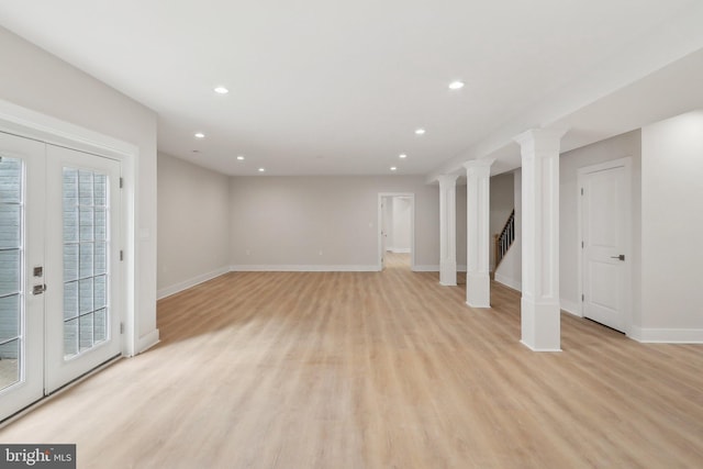 below grade area featuring recessed lighting, baseboards, stairway, and light wood finished floors