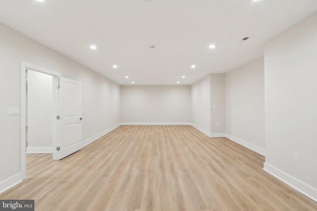 unfurnished room featuring light wood finished floors, baseboards, and recessed lighting