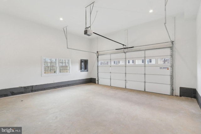 garage featuring electric panel and a garage door opener