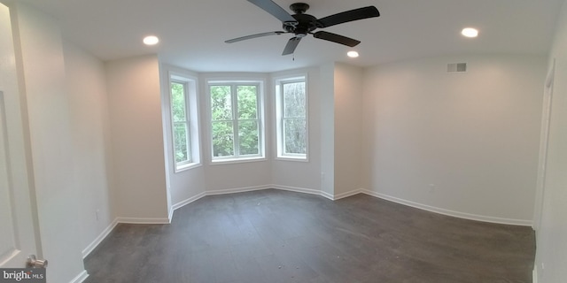 spare room featuring ceiling fan and dark hardwood / wood-style flooring