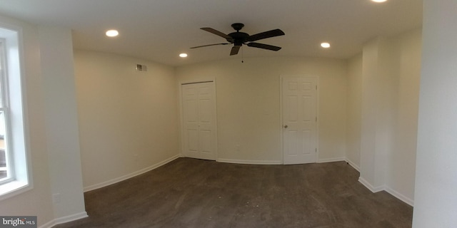 empty room featuring ceiling fan and dark hardwood / wood-style floors