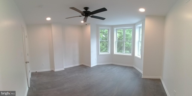 empty room featuring dark hardwood / wood-style flooring and ceiling fan