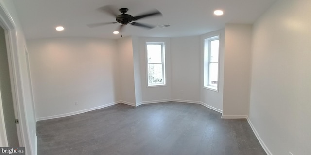 spare room with dark hardwood / wood-style floors and ceiling fan