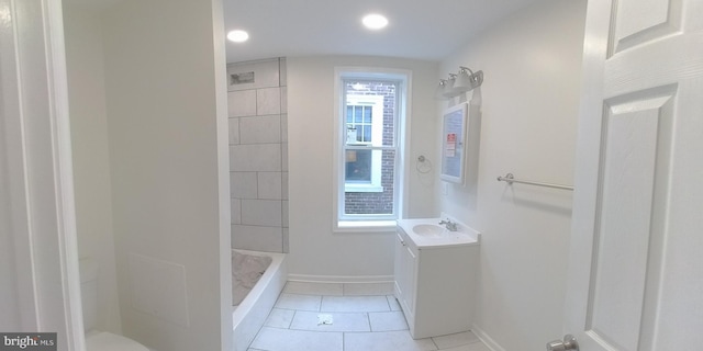 bathroom featuring tile patterned flooring, vanity, and walk in shower