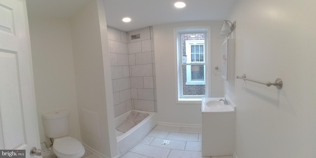 bathroom with vanity, tile patterned floors, toilet, and tiled shower