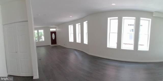 entrance foyer with dark hardwood / wood-style floors and a wall mounted AC