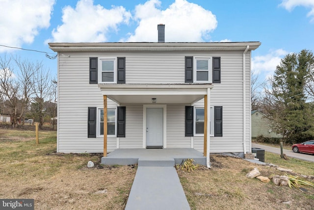 view of property with a front yard and a porch