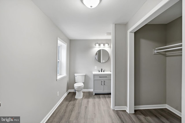 bathroom featuring hardwood / wood-style flooring, vanity, and toilet