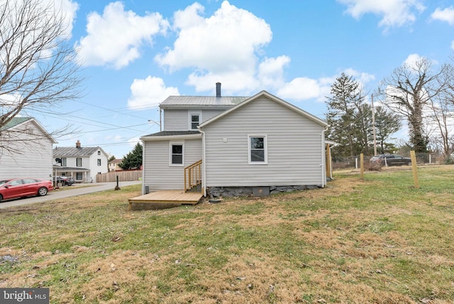 rear view of property with a yard