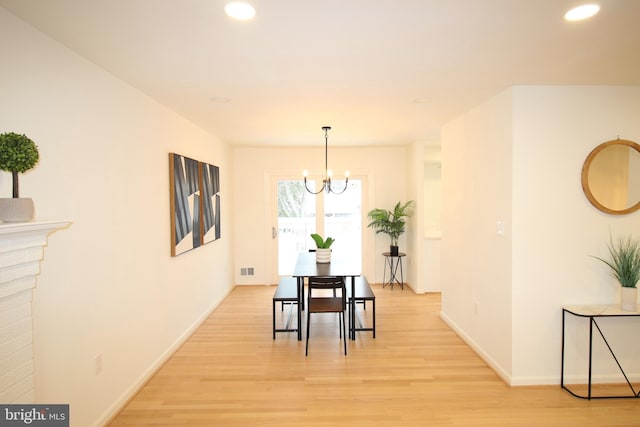 dining room featuring an inviting chandelier and light wood-type flooring