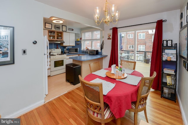 dining space featuring a chandelier and light hardwood / wood-style floors